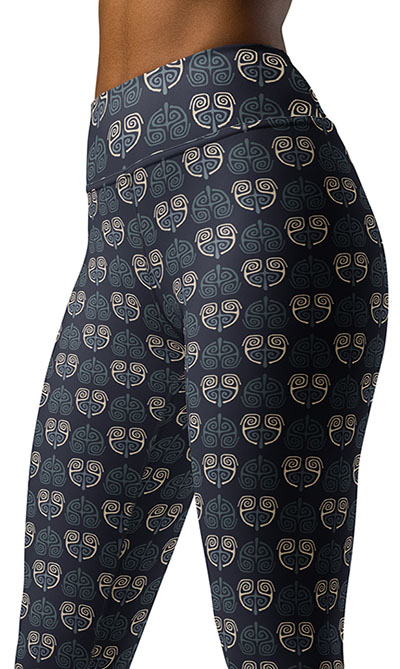 Close up of yoga leggings waistband with art deco tattoo print in light blue and beige on dark blue.